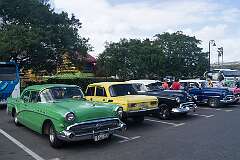 Vintage cars parked outside the Parque Luz Caballero in Havana, Cuba.