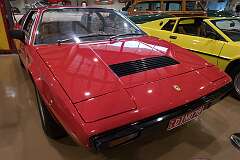A  Ferrari 308 GT4 (introduced in 1973 as Dino 308 GT4),  a V6 mid-engined sports coupe designed by Marcello Gandini at Bertone.