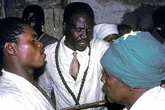 Mbabane, Eswatini, 1970 - Praying for a woman during a Sunday service in a “Zionist” African church in Msunduza township.