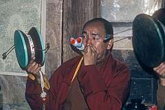 Tarke Ghyang, Nepal, 1979 - A Buddhist Lama with a flute, made from a human bone, and a hand drum during a “Tsokla” ceremony.