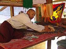 Bago, Myanmar, 2006 - Paying homage in a “Snake Monastery” to the 115 year old boa constrictor, believed to be the reincarnation of an abbot.