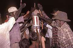Borroloola, NT, Australia, 1981 - “Hitting the head” of a decorated pole, representing a deceased person, in the Yalkawaru ceremony of the Yanyuwa people.
