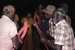 Barunga, NT, Australia, 1982 - Men singing, accompanying themselves with boomerangs, at a “Mandiwa” Aboriginal initiation ceremony.