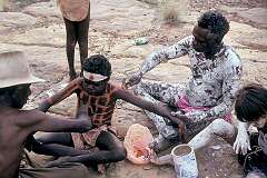 Borroloola, NT, Australia, 1992 - A young Yanyuwa boy being painted with red ochre during his initiation ceremony.