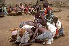 Bethany, Eswatini, 1972 - Candidate “tangoma” trying to eat pieces of raw liver of a goat, just killed in their “iNtfwasa” ceremony; the Swazi word for liver, “sibindzi”, also means courage.