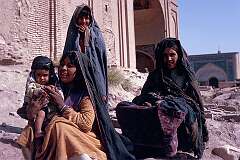 Women and girls of the Kuchi people, one of the nomadic peoples of Afghanistan, near a mosque on the outskirts of Herat. Kuchi women don't wear the all-covering “burqa”.