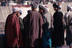A group of Pashtu (or Pathan) men having a discussion on the street. The Pashtun people are the dominant ethnic and linguistic community, about half the population of Afghanistan.