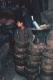 In Kabul's bazaar in Kabul a boy sells bowls of manure that will be used as fuel.