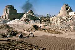 Bricks are cut by hand near the kilns where they will be baked, in the village of Deh Khatay, just outside Kandahar.