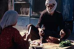 Preparing minced meat and onions for a stew outside one of the many small eating places in Mazar.