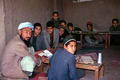 A teacher and his students in a small school, open to the street, in Mazar-e-Sharif. These boys were later heard chanting passages from the holy Qur'an.