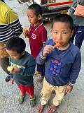 Boys having ice cream, having a pause on the trip.