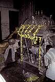 Celebrants prepare a richly decorated platform with a statue of a deity in the Sri Meenakshi Temple.
