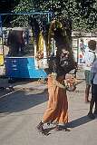 Pulling a cart with sacred objects, collecting donations in Madurai.