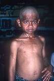 A boy after he had his head shaved; It signifies purification, a new beginning, and a complete surrender of one's identity to the divine.