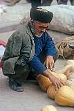 A Turkmeni man selling melons on the market in Aqqala.