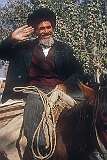 A Turkmeni man on a horse giving a salute, in Aqqala.