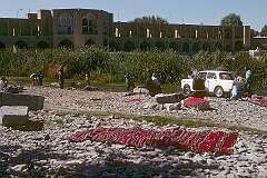 Washing car and carpets in the Zayandeh Rud river, with the Pol-e Khaju, a bridge built by Shah Abbas II in 1650 in the background. It is 123 metres long with 24 arches.