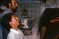 Baking bread in a traditional oven in the bazaar of Isfahan.