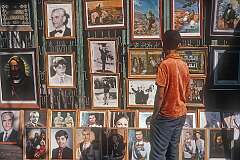 Display  in Tehran of photos of Mohammad Reza Pahlavi, the last Shah of Iran, with his (third) wife Farah Diba and their son Reza Pahlavi, the Crown Prince; and images depicting the Prophet Ali, one of the central figures in Shia Islam as the first Shia Imam.