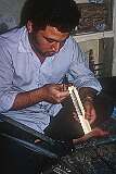 Working on a piece, using Khātam, an ancient Persian technique, decorating wooden articles with delicate pieces of wood, bone and metal precisely-cut intricate geometric patterns.