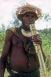 Tari, Papua New Guinea, 1979 - A Huli man playing a bamboo pan flute.