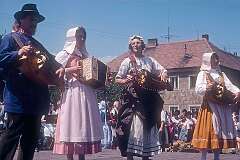 Strážnice, Morava, Czechia, 1989 - Playing hurdy-gurdy and accordion by “Les Compagnons de Barenzai” from France.