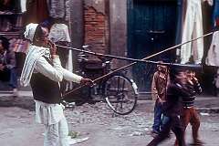Kathmandu, Nepal, 1979 - Playing a long and very loud horn in a procession.