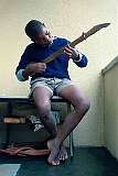 Mbabane, Eswatini, 1972 - A Swazi boy with a home-made guitar.