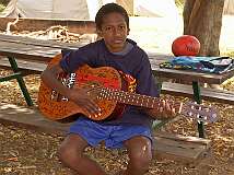 Weipa, Queensland, Australia, 2006 - A Torres Strait Islander boy, strumming a guitar.
