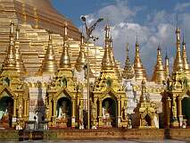 Yangon, Myanmar, 2006 - Small shrines with Buddha statues at the base of the huge stupa of Shwedagon Paya.