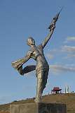 A statue of Yuri Gagarin, the first (Soviet) cosmonaut, in a heroic pose, dressed in a loincloth and holding aloft a space rocket, at Mandaliin Khar Ovoo in  Mandalgov, Mongolia.