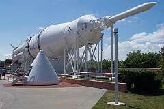 Saturn V, the three-stage super heavy-lift launch vehicle, developed to support the Apollo program for human exploration of the Moon; in the Rocket Garden display.
