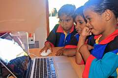 Gordonvale, Queensland, Australia, 2010 - Aboriginal girls at Djarragun College playing a computer game.