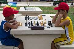 Havana, Cuba, 2016 - Boys playing chess, Plaza del Cristo.