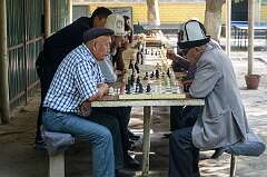 Osh, Kyrgyzstan, 2017 - Men playing chess in Park Navoi.
