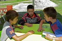 Theth, Malësi e Madhe, Albania, 2009 - Boys playing a game at Guesthouse Prek Harusha.